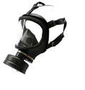 Full-face black gas mask with wide panoramic clear lens, rubber face seal, single round filter canister, and adjustable head harness straps, angled view on white background.