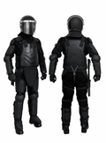Turbo-X full body riot control suit shown from front and rear on mannequins, featuring black helmet with tinted visor, molded chest and back armor, shoulder guards, elbow and knee pads, shin guards, and baton holder, on white background.